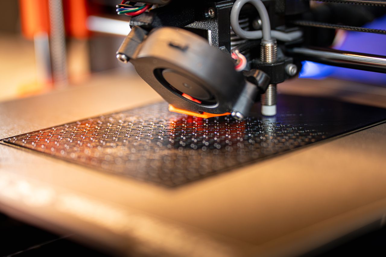 Detailed view of a 3D printer in action, showcasing cutting-edge manufacturing technology.